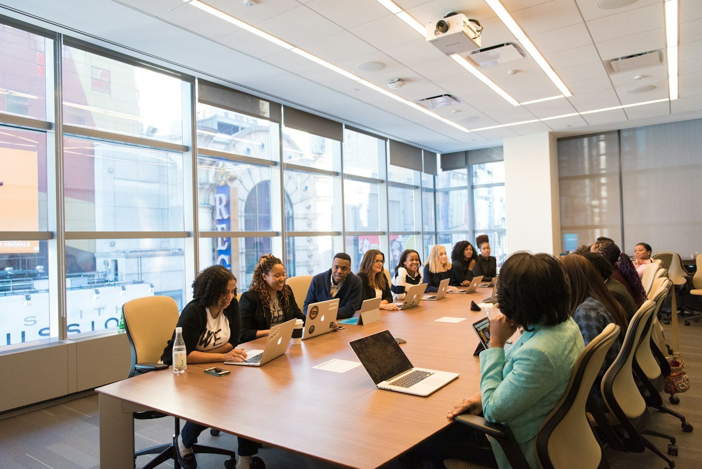 Team meeting around a table with laptops