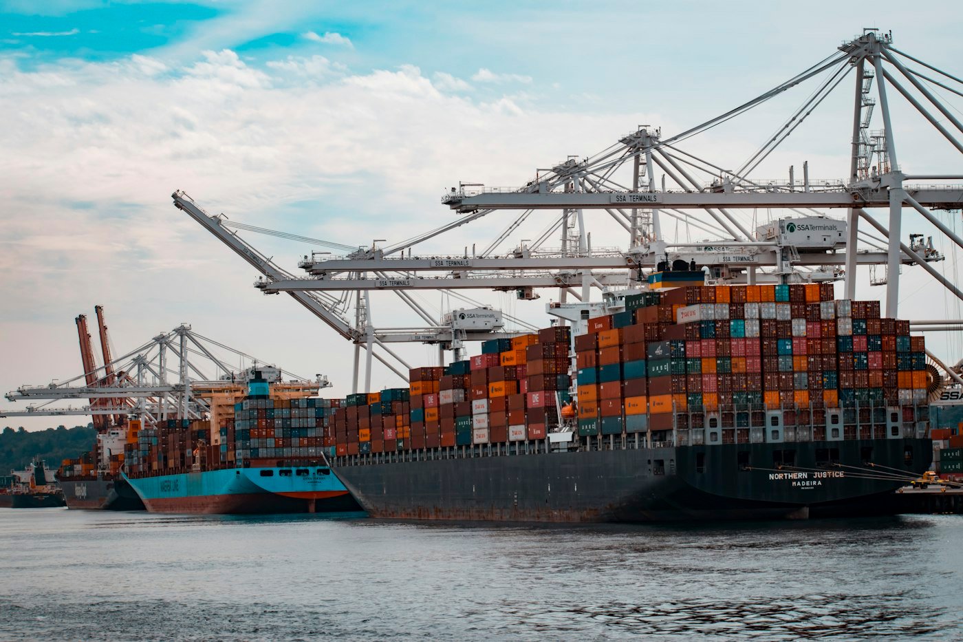 Cargo ships loaded with containers docked at a pier
