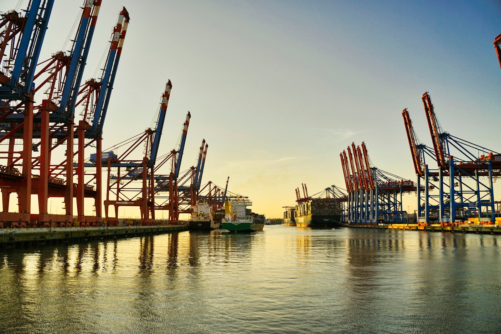 Container cranes at a port at golden hour